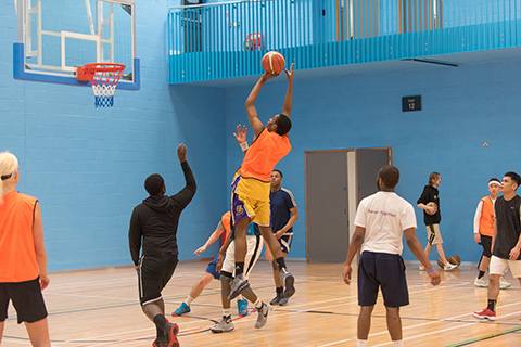 Player jumping for basketball shot