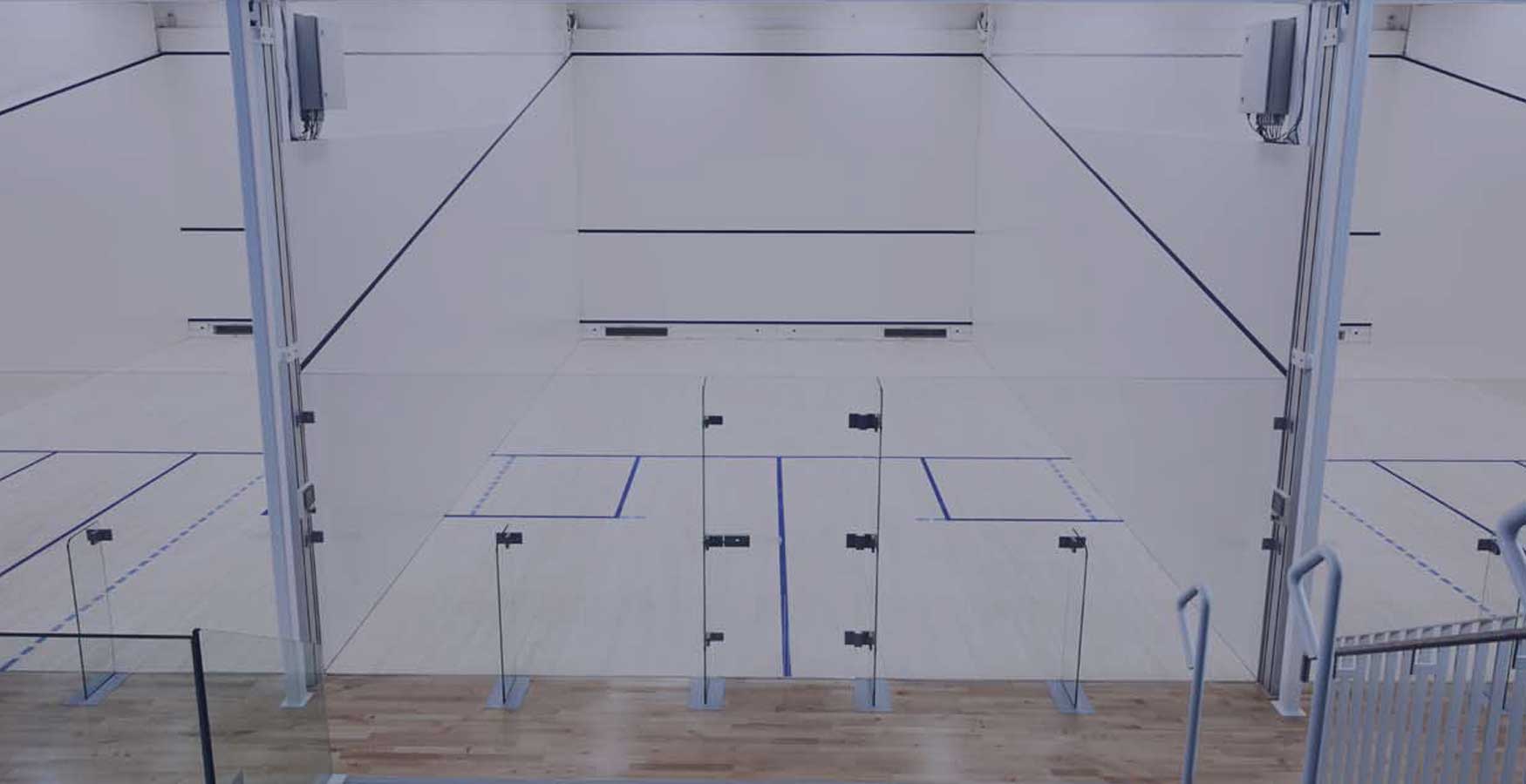 a row of 3 glass-back squash courts