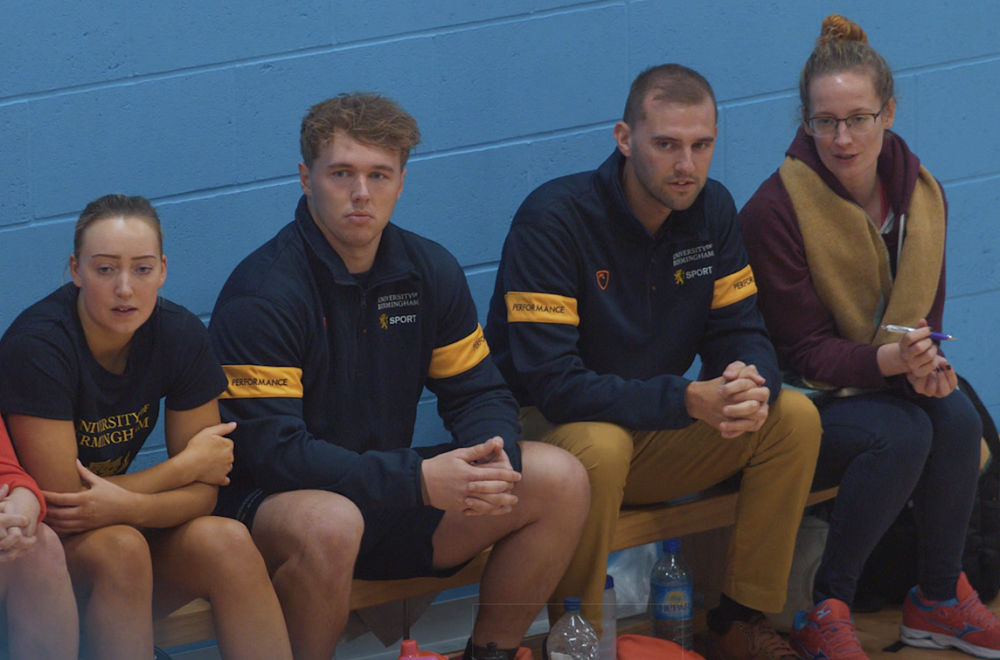 Sport & Fitness practitioners sitting on a bench with a student athlete