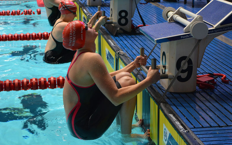 UoB swimmer ready to start a race on the starting blocks
