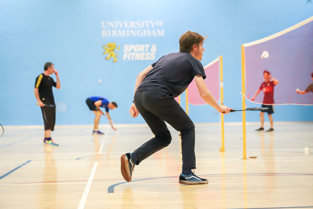 Male Badminton player hitting the shuttlecock