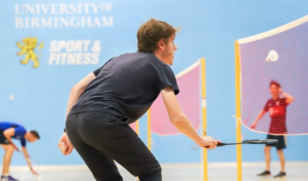 Male Badminton player hitting the shuttlecock