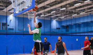 Basketball player jumping next to the hoop