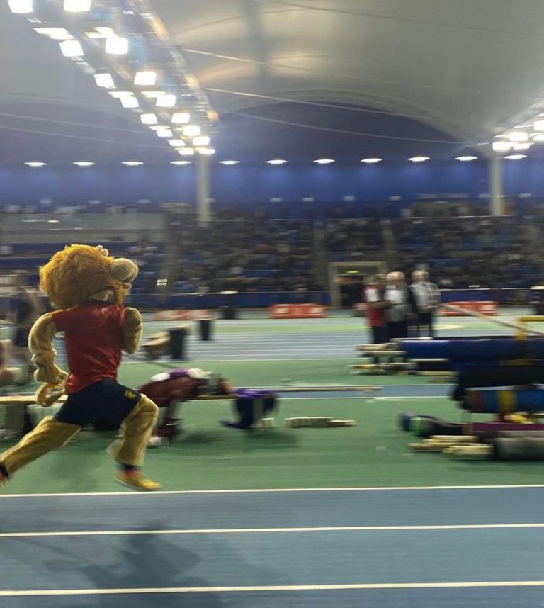 Rory the Lion mascot running on the indoor track at BUCS Nationals