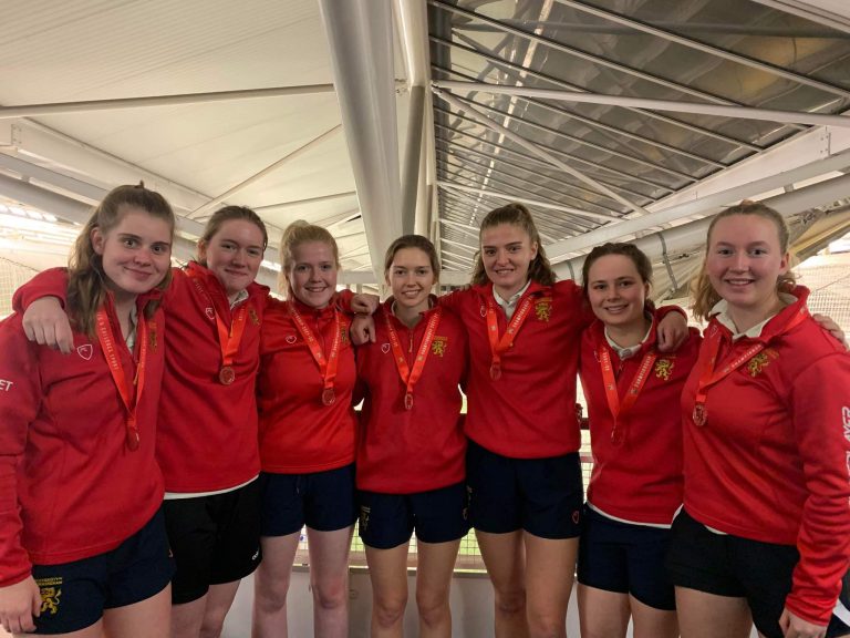 Seven of the women's cricket team stoof with their bronze medals at the National Indoor Finals