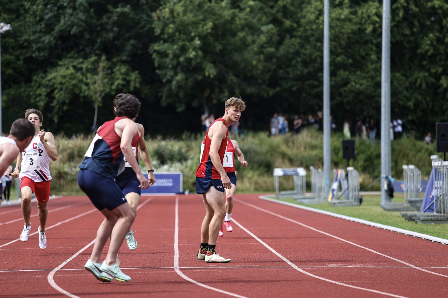 Athletics squad in relay race on UoB running track