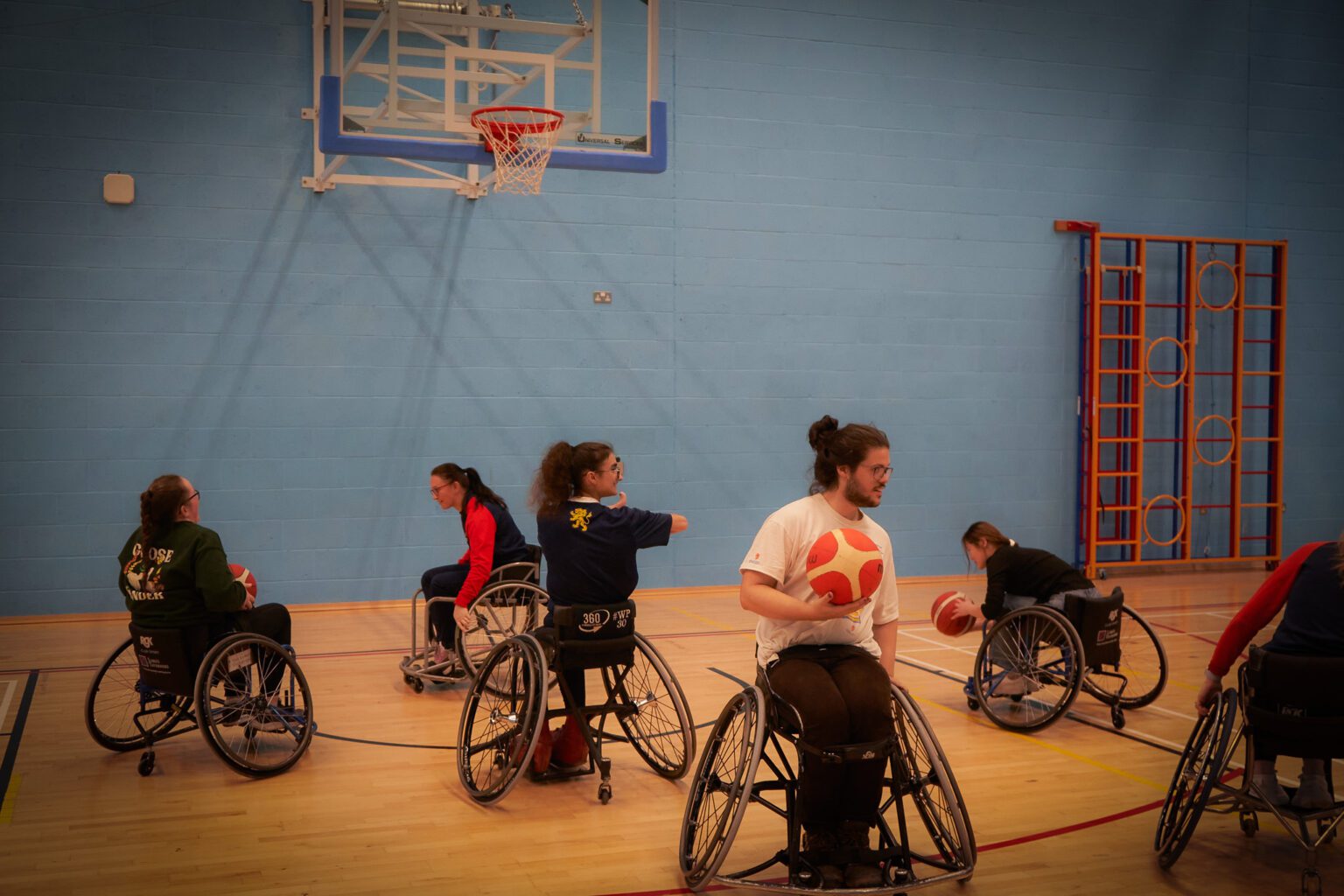 Group of students playing wheelchair basketball at Sport & Fitness Munrow Arena.