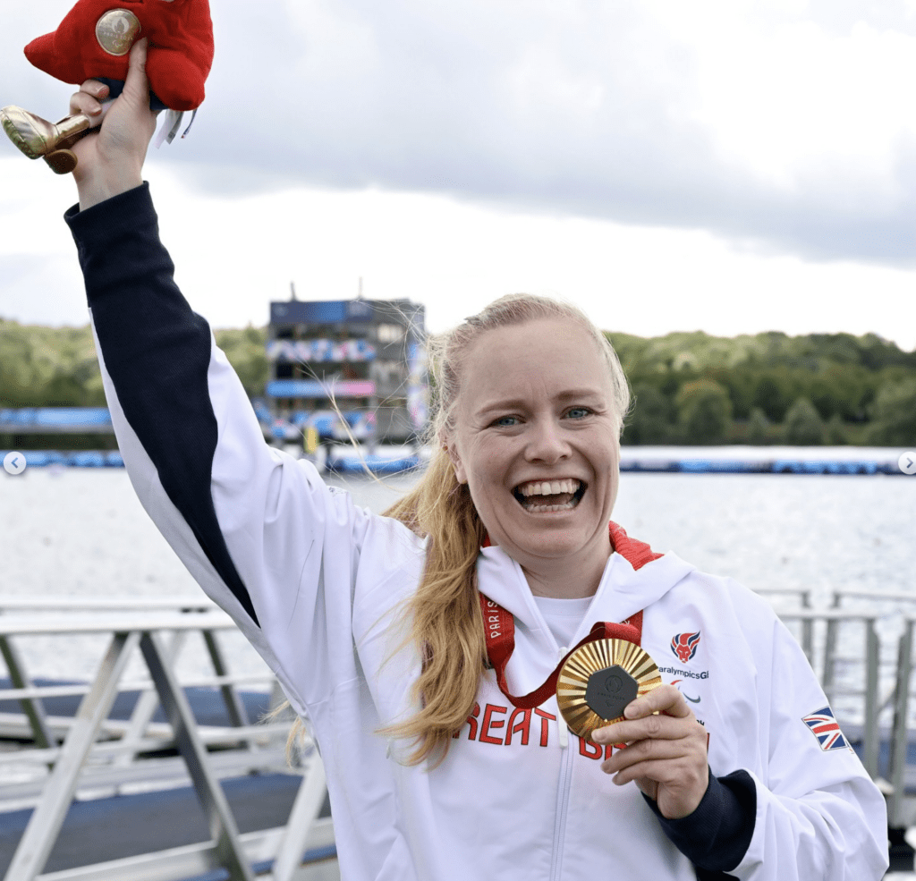 Laura Sugar holding gold medal smiling