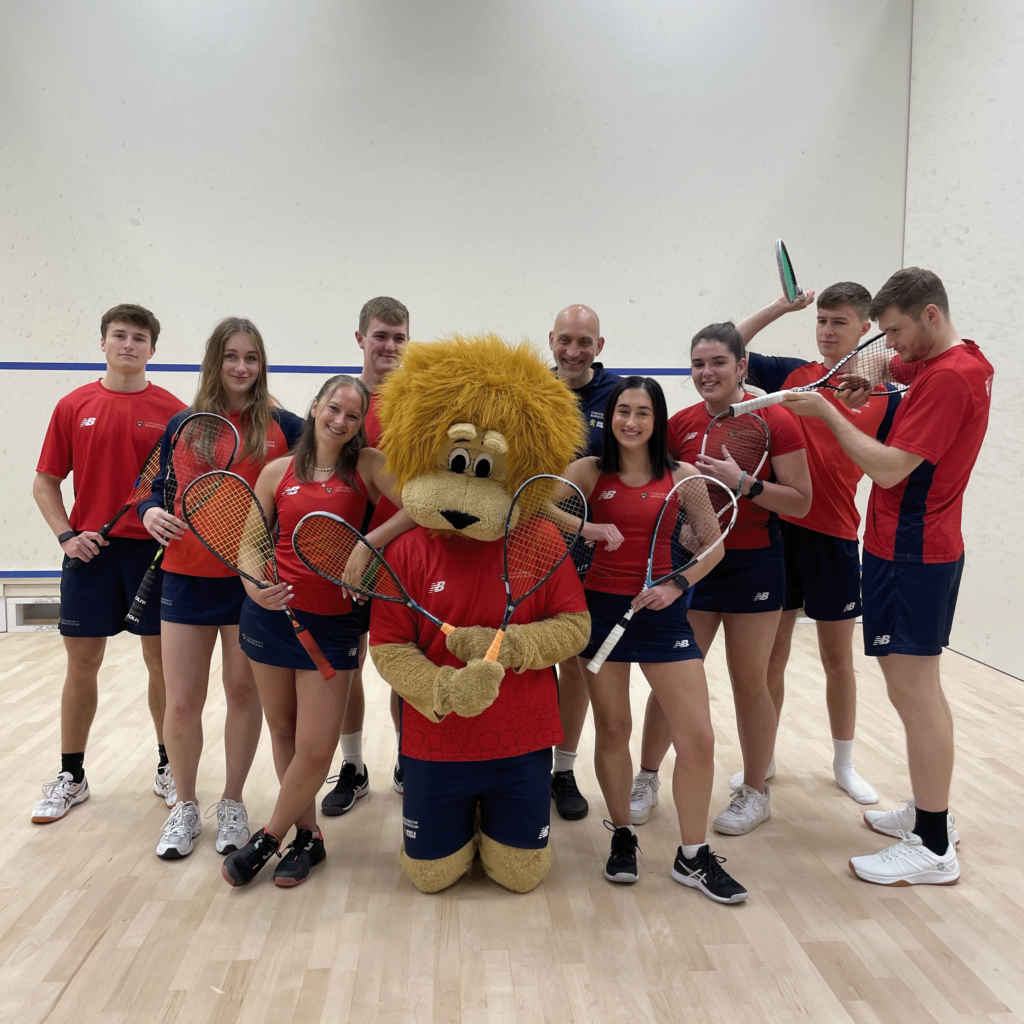 Squash team together with Rory the Lion.