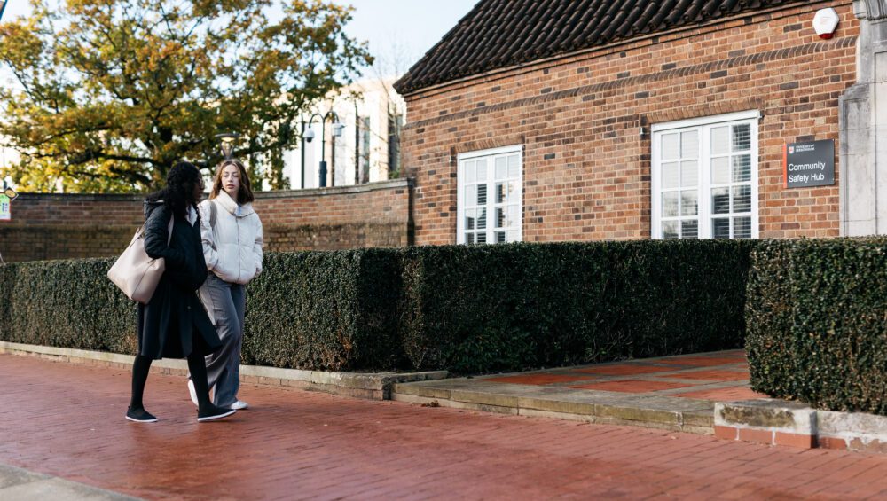 Two female students walking on campus