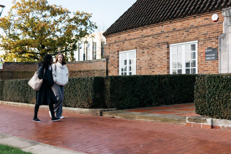 Two female students walking on campus