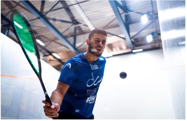 Moustafa playing Squash hitting ball