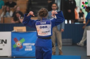 Summer pointing at her name on back of GB Judo kit