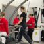 Woman on treadmill in performance lab with concussion student staff supporting